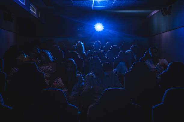 Movie theater Silhouette of people watching a movie in a cinema. film festival photos stock pictures, royalty-free photos & images