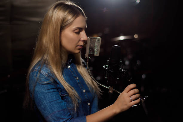 istock Blonde singing woman in a recording studio 1148465752