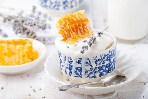 Ice cream with honey and lavender in bowls. White background