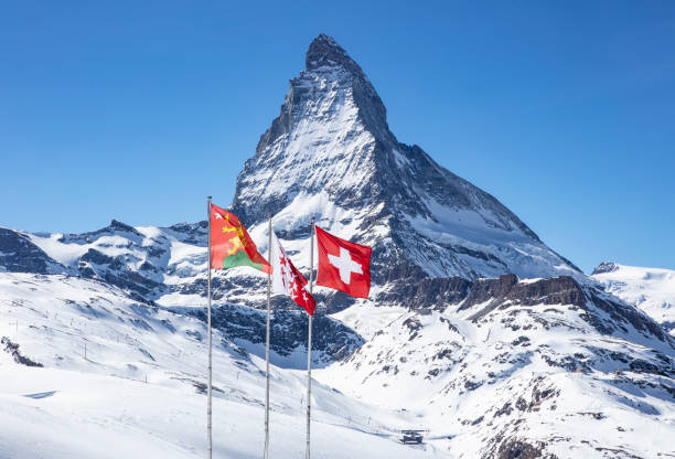 istock The Matterhorn with Swiss Flags 1148469174