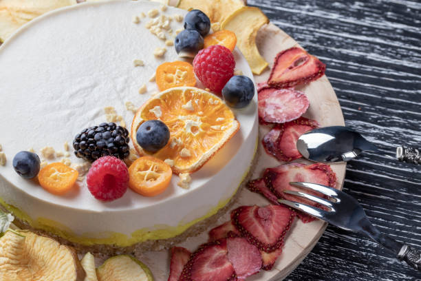 istock Dietary delicate fruity berry nut cake without baking. Wooden stand on a black table. 1148470394