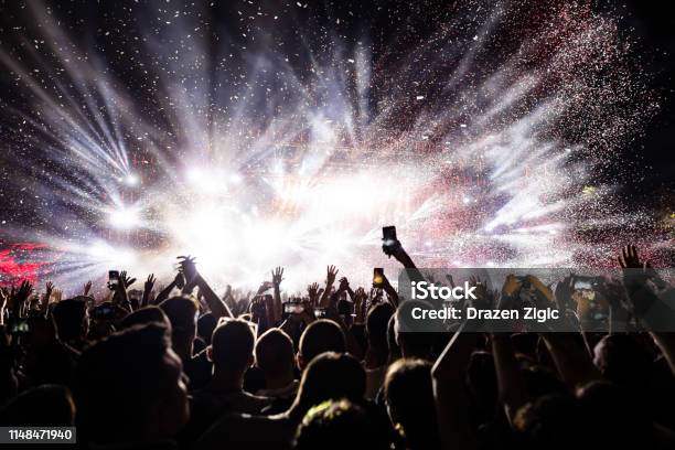 Confetti Fireworks Above The Crowd On Music Festival Stock Photo - Download Image Now