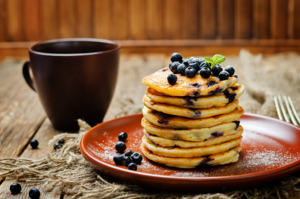 Blueberry Ricotta Pancakes with fresh blueberries and cup of coffee