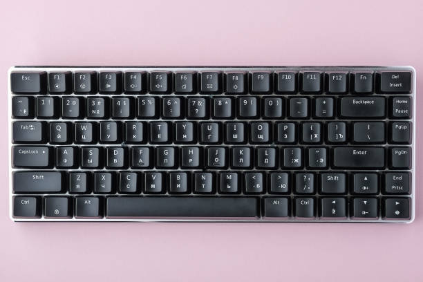 istock Black mechanical keyboard on pink background 1148479031