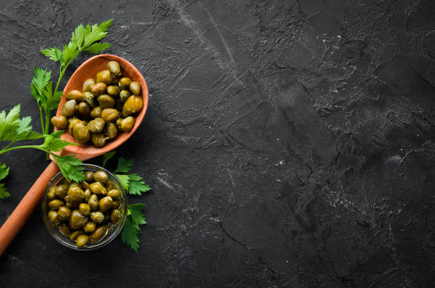 istock Capers Marinated capers in a bowl. Top view. free space for your text. 1148485697