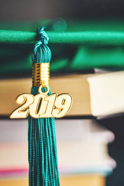 istock Green mortarboard with 2019 Graduation tassel and books 1148489484
