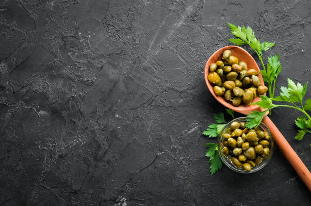 istock Capers Marinated capers in a bowl. Top view. free space for your text. 1148495955