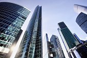 Office and residential skyscrapers against bright sun and clear blue sky