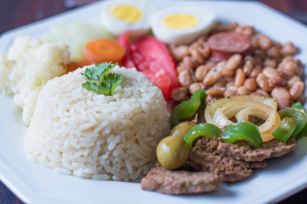 istock Brazilian food dish - Beans, rice, meat, eggs, salad 1148496372