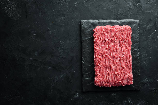istock Minced meat. Meat and spices on the old table. Top view. Free space for your text. 1148497255