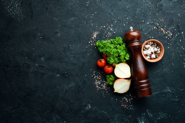 istock Cooking banner. Vegetables and spices on a black background. Free space for your text. Rustic style. 1148499109
