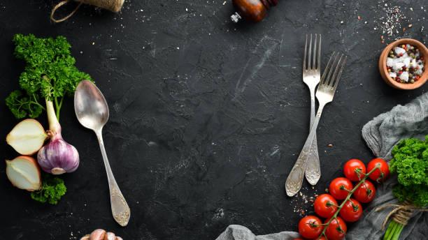 istock Cooking banner. Vegetables and spices on a black background. Free space for your text. Rustic style. 1148499267