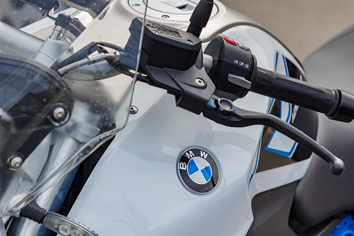 Moscow, Russia - May 04, 2019: BMW emblem on white glossy fuel tank of sports motorcycle. Moto festival MosMotoFest 2019