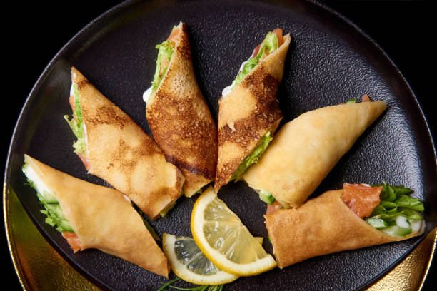 istock Pancakes with filling and lemon slices on a dish. 1148503354