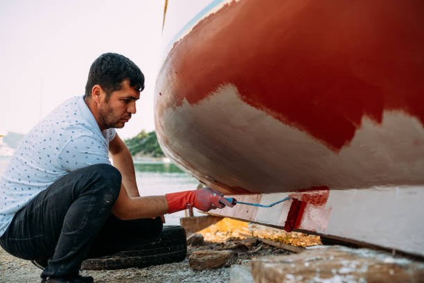 istock Man Painting His Boat 1148503504