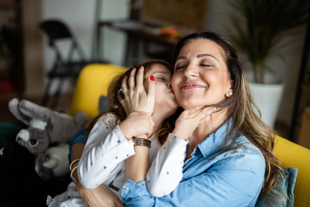 istock Mother cuddling with her daughter 1148513257