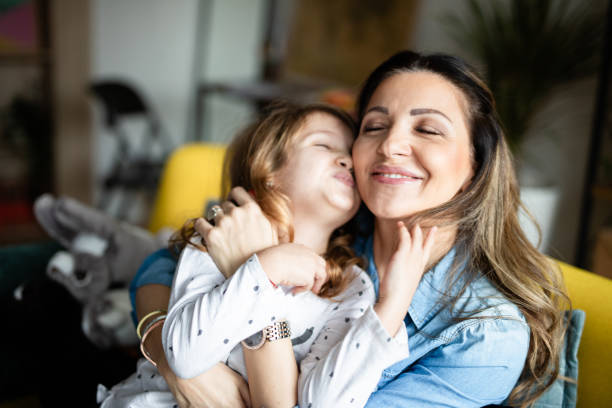 istock Mother cuddling with her daughter 1148513283