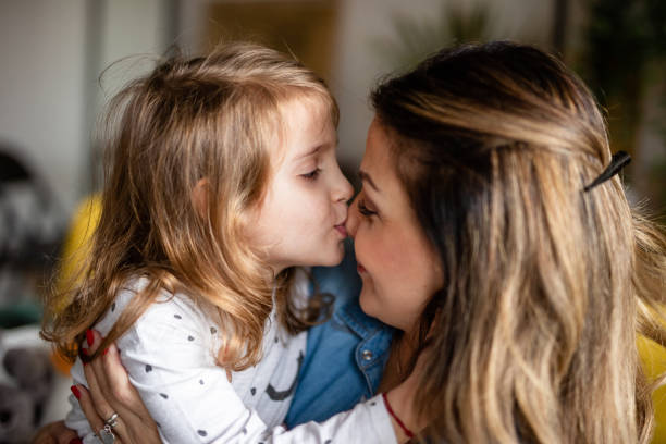 istock Mother cuddling with her daughter 1148513325