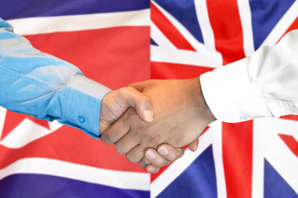 istock handshake on North Korea and UK flag background. 1148514155