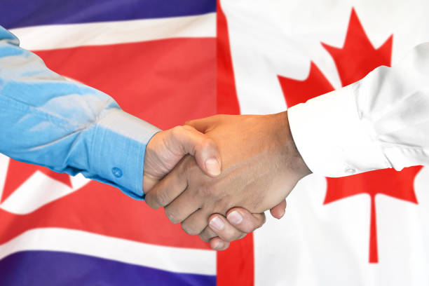 istock handshake on North Korea and Canada flag background. 1148514199