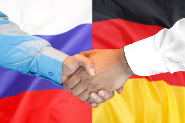 istock handshake on Germany and Russia flag background. 1148514245