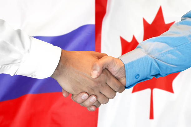 istock handshake on Canada and Russia flag background. 1148514367