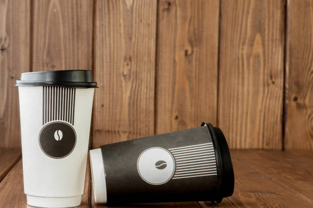 istock Take-out coffee in thermo cup on a wooden background, Copy space. 1148514419