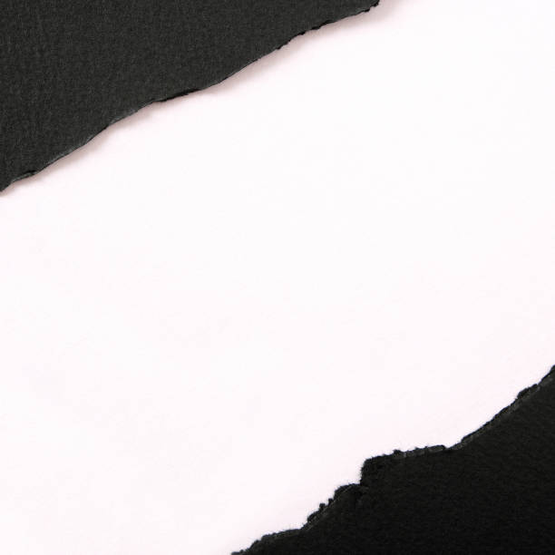 istock Torn black paper strip diagonal white background square 1148515700