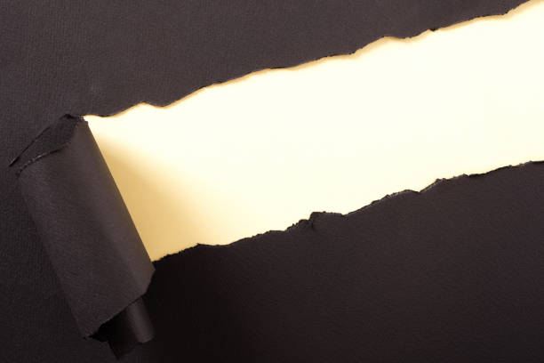 istock Torn black paper strip yellow background diagonal angle 1148515775