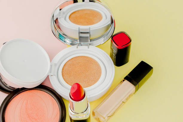 istock Make up products spilling on to a bright yellow and pink background with copy space 1148515806
