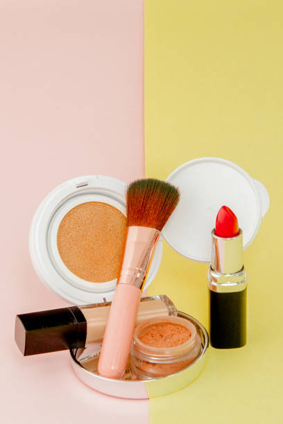 istock Make up products spilling on to a bright yellow and pink background with copy space 1148515833