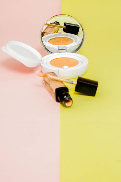istock Make up products spilling on to a bright yellow and pink background with copy space 1148515848