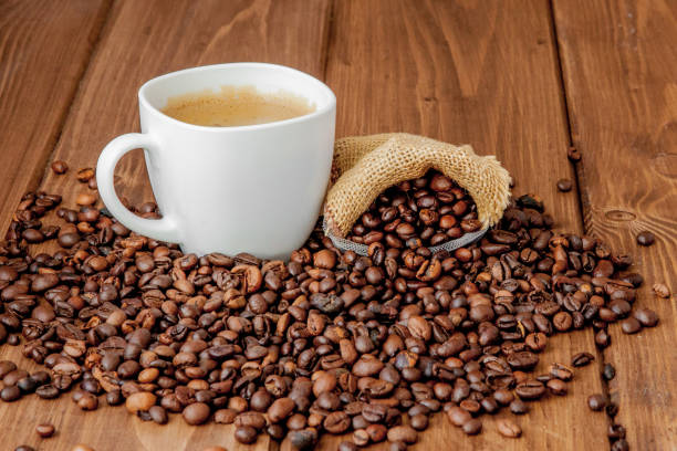 istock Coffee cup with coffee bag on wooden table. View from top 1148517779