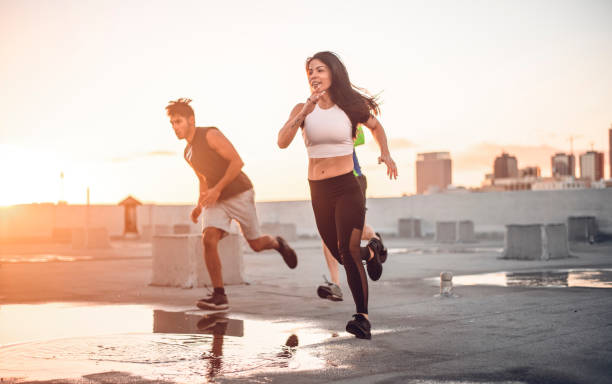 istock Friends jogging together on terrace against sky 1148520400