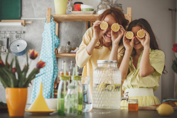 istock Mother and daughter having fun making lemonade at home 1148520754