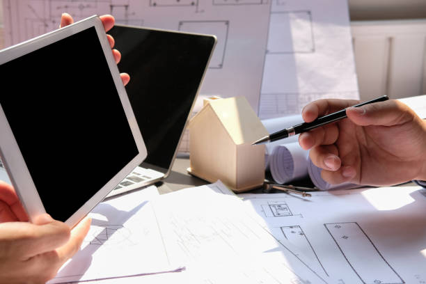 istock architect engineer team working on house blueprint of real estate project at workplace. construction & building concept 1148520817