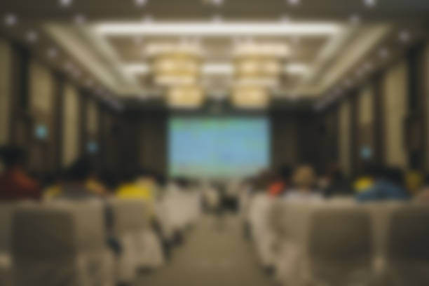 istock audience & stage in seminar conference room. blur background 1148521045
