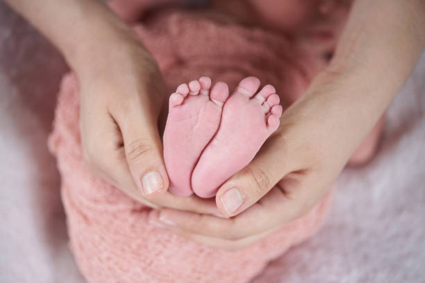 istock Mother hold newborn toes 1148525368