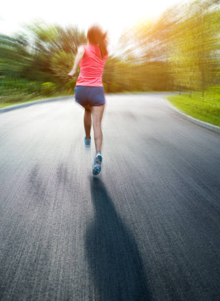 istock Young asian woman jogging in a park 1148526061