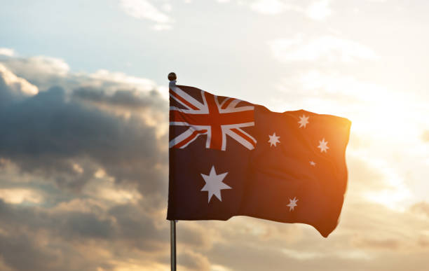 Waving Australia flag in the air at sunset.