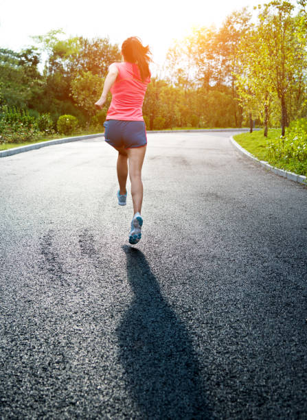 istock Young asian woman jogging in a park 1148526177