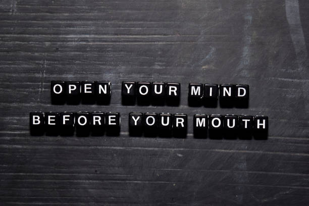 open your mind before your mouth on wooden blocks. education, motivation and inspiration concept - single word love wood typescript imagens e fotografias de stock