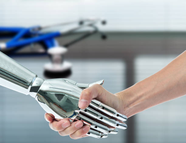 istock Man shaking hand with robot in doctor office 1148531641