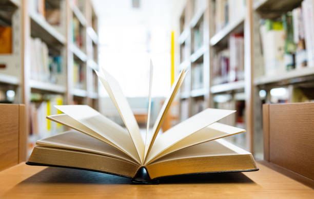 istock Open book on the desk of library 1148532473