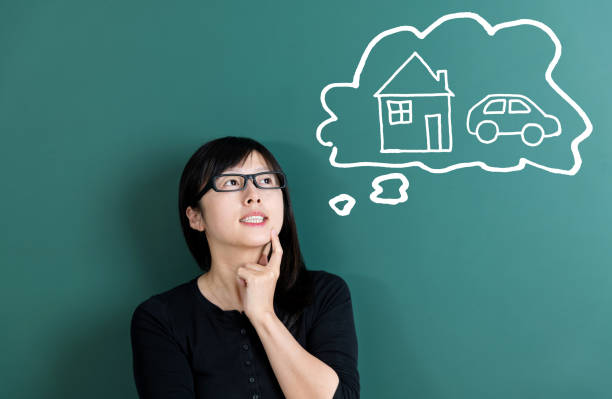 istock Woman dreaming about house and car 1148534992