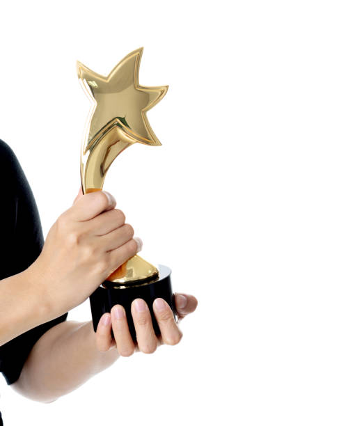 istock Woman hand holding a golden trophy 1148535542