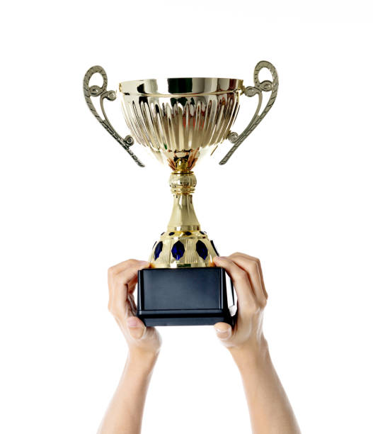 Woman hand holding a golden trophy