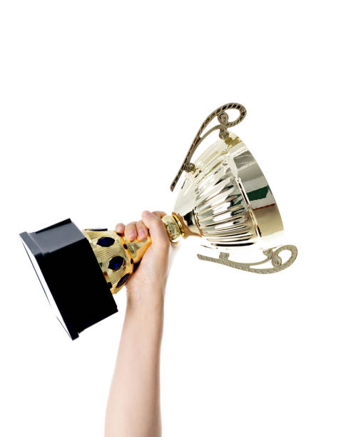 istock Woman hand holding a golden trophy 1148535574