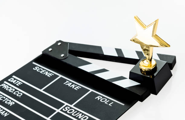 film slate and golden award on white background - effort gold indoors studio shot imagens e fotografias de stock