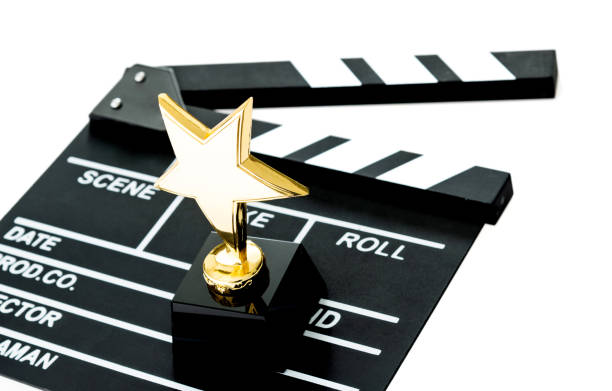 film slate and golden award on white background - effort gold indoors studio shot imagens e fotografias de stock